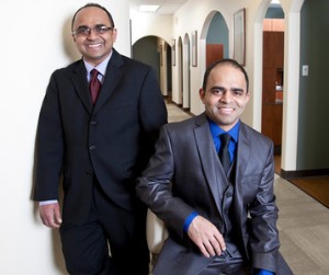 Portrait photo of Drs. Jay and Hemu Patel; Dr. Hemu Patel seated with Dr. Jay Patel standing